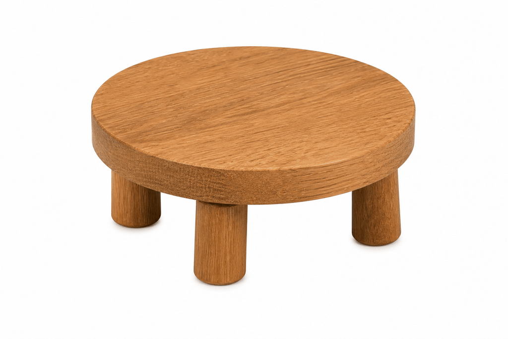 Wooden stool with a round top and four legs on a white background