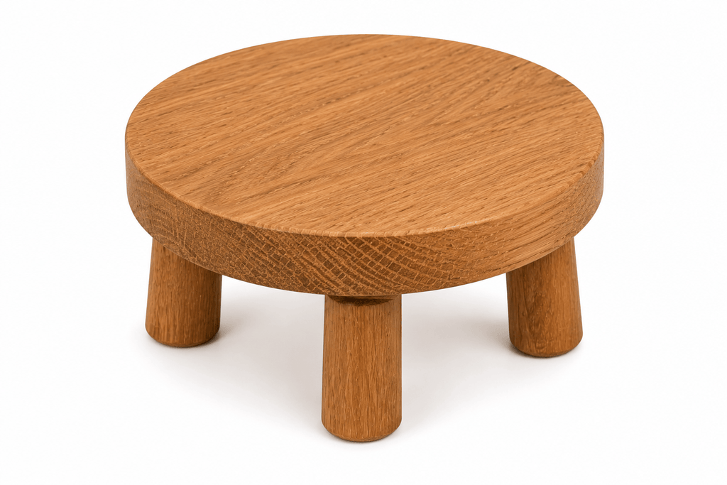 Wooden stool with a round top and four legs on a white background