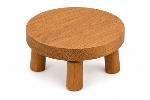 Wooden stool with a round top and four legs on a white background